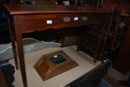 A Walnut/Satinwood side/writing Table having a central frieze drawer with oval backplate drop