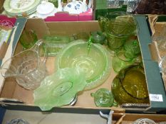 A quantity of green glass including jugs, butter dish and lidded pots, plus one clear glass jug.