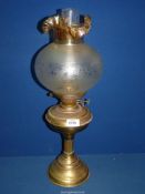 A Brass paraffin Lamp with, frosted lamp shade with fluted top, 22" high.