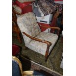 An open armed Fireside Armchair having turned and fluted front legs,