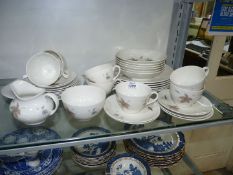 A Royal Doulton 'Tumbling Leaves' part dinner/tea set to include six dinner plates, six bowls,