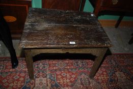 An early Oak peg-joyned rectangular Table having a two plank top and standing on tapering square