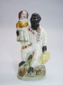 A Staffordshire figure of 'Uncle Tom and Eva', circa 1850, small chips to the base, 4 3/4'' tall.