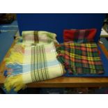 A double 'Weltex' blanket in plaid green, blue and yellow and two Tartan wool travel rugs.