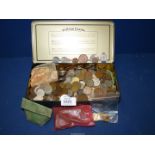 A tin of British and foreign coins including a bag of unused 1/2 pennies, Australian coins, Mexican,
