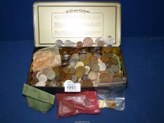 A tin of British and foreign coins including a bag of unused 1/2 pennies, Australian coins, Mexican,