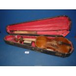 A cased Violin, in need of repair.
