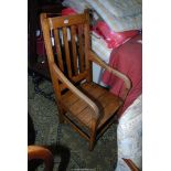 A mixed hardwood solid seated open armed Elbow Chair standing on square legs united by perimeter