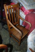 A mixed hardwood solid seated open armed Elbow Chair standing on square legs united by perimeter