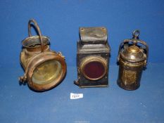 Three old lamps including one by Wolf Safety Lamp Co., Sheffield, rear lamp, etc.