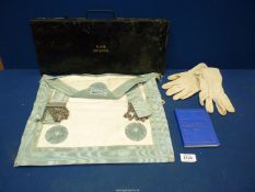 A Masonic apron and gloves in metal case bearing initials C.A.E. No. 2186.