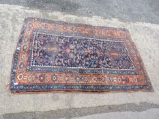 A navy blue and terracotta bordered and patterned Rug in geometric pattern, 48" x 75 1/2".