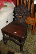 A solid seated Mahogany Hall Chair having turned front legs and an "H" stretcher and front arched