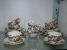 A set of six Japanese 'Cockerel' porcelain cups, saucers, side plates and a jug.