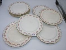 A quantity of Booth's Silicone ware dinner plates with swags of roses and polka dots border pattern