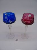 A pair of Bohemian crystal goblets; one cranberry, one blue,