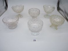 A quantity of dessert bowls with stems in various designs.