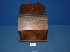 An antique Oak Salt Box with heart shape detail to back and having leather studded hinge to lid,