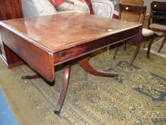 A 19th century Mahogany rectangular Dining/Centre Table having narrow drop leaves and raised on a