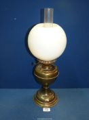 A Brass oil lamp with chimney and white glass shade (some chips), 20 1/4" tall.