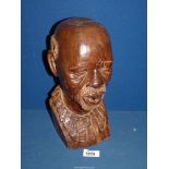 An African head sculpture of an elderly tribesman, 12" tall.