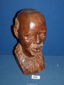 An African head sculpture of an elderly tribesman, 12" tall.