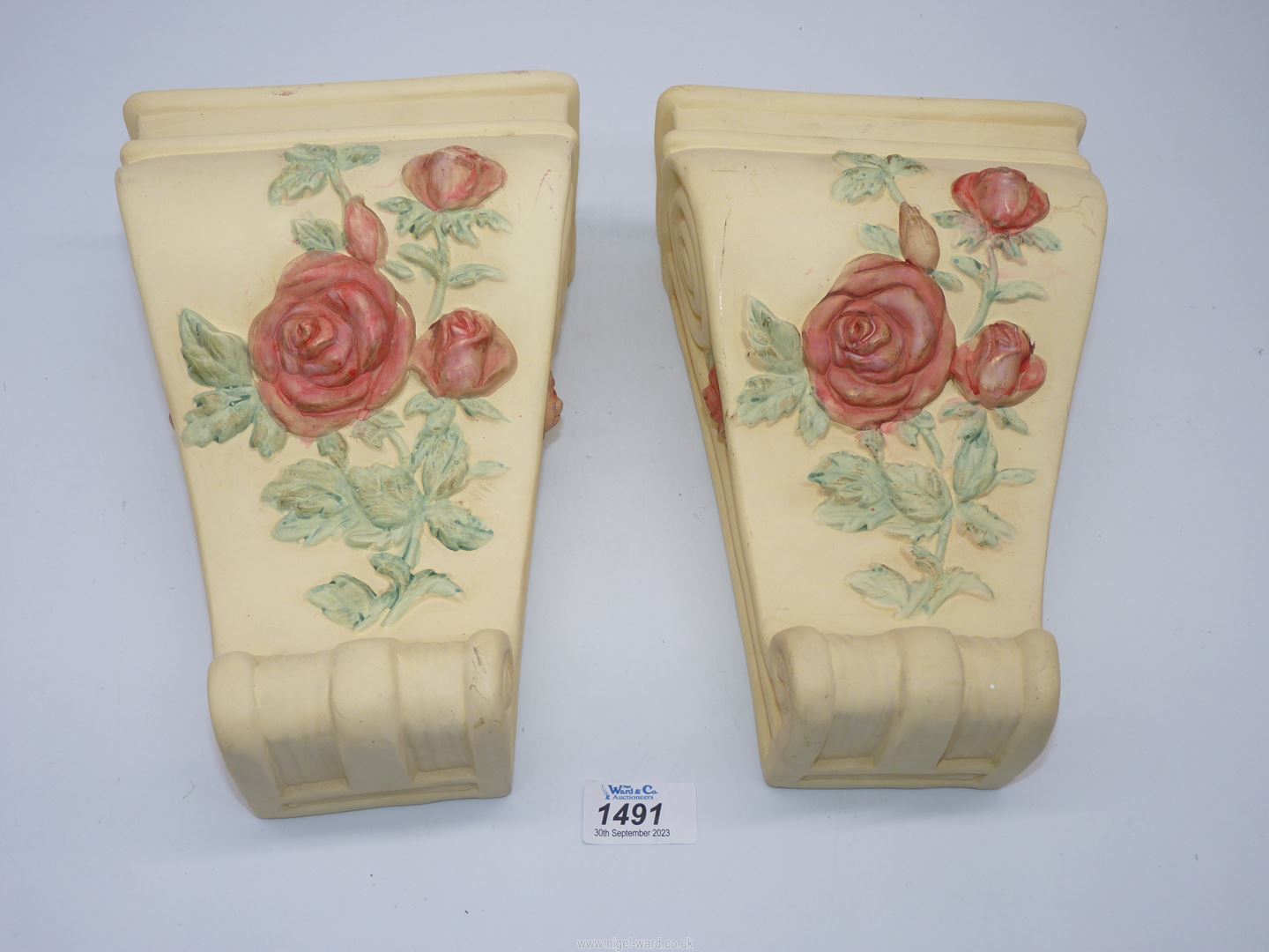 A pair of decorative ceramic corbels.
