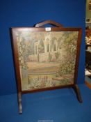 A Firescreen with inset tapestry of a classical garden scene, 21'' wide x 26 1/2'' high.
