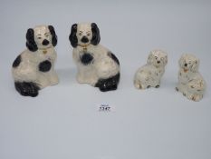 Two pairs of Beswick spaniels; one pair in black and white with gold padlocks (5 1/2" tall),
