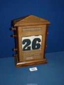 A wooden perpetual calendar 11" high x 6 1/2" wide.