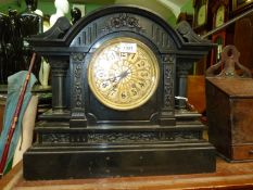 A very heavy and imposing black marble/slate mantel clock the gilded detail face with Arabic