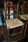 A charming child's CHair of primitive construction and considerable age,
