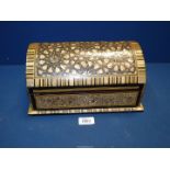A large 20th Century dome topped casket inlaid with Mother of Pearl detail and having red felt