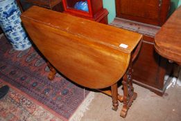 A Mahogany/Satinwood Sutherland table having intricately fretworked end supports and turned legs