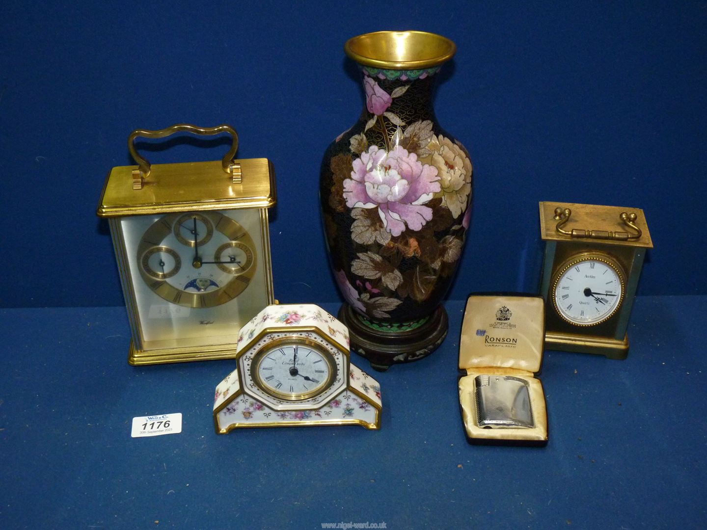 Two quartz carriage clocks, a Royal Crown Derby miniature mantle clock,