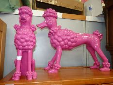 Two large pink ceramic Poodles.