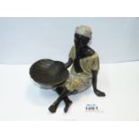 An unusual, cold painted bronze of a man sitting crossed legged