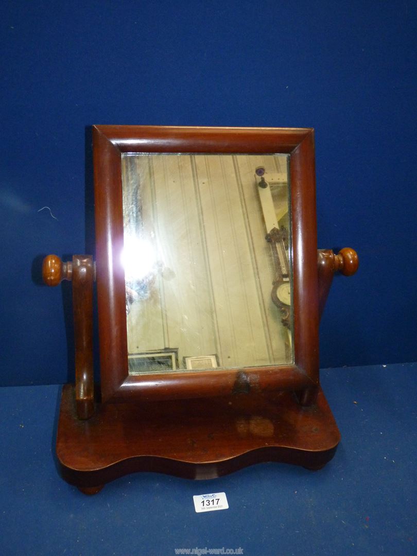 A small swing mirror on bun feet, 13" wide x 15" high x 5 1/2" deep.