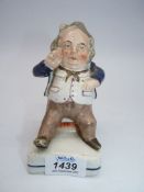 A mid 19th c Staffordshire figure of a portly gentleman sitting on a stool,
