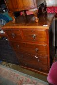 A narrow Walnut Chest of three long and two short Drawers having brass tear-drop handles and