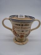 An English Creamware loving cup with frog interior, named and dated 'Peter Battes 1802', a/f.