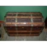 A domed top steamer trunk 33 1/4" wide x 22 1/2" high x 19" deep, some damage to top.