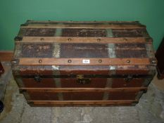 A domed top steamer trunk 33 1/4" wide x 22 1/2" high x 19" deep, some damage to top.