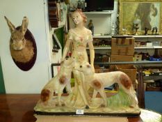 A chalk figure of a lady with two hounds (a/f), 22" wide x 21" high.