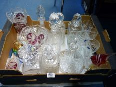 A quantity of glass decanters, vases with red panels, paperweights, wine glasses, etc.