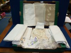 A large quantity of linen including tablecloths, embroidered napkins, lace doilies, etc.