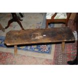 An Elm topped Pig Bench, one replacement leg loose, 45'' long x 12 5/8'' x 14 1/4'' high approx.