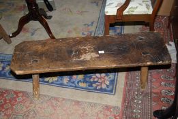 An Elm topped Pig Bench, one replacement leg loose, 45'' long x 12 5/8'' x 14 1/4'' high approx.