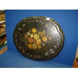 A black papier mache table top with central floral motif, 28" x 22 1/2".