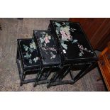 A nest of three black lacquered chinoiserie occasional Tables having decorated with flowering